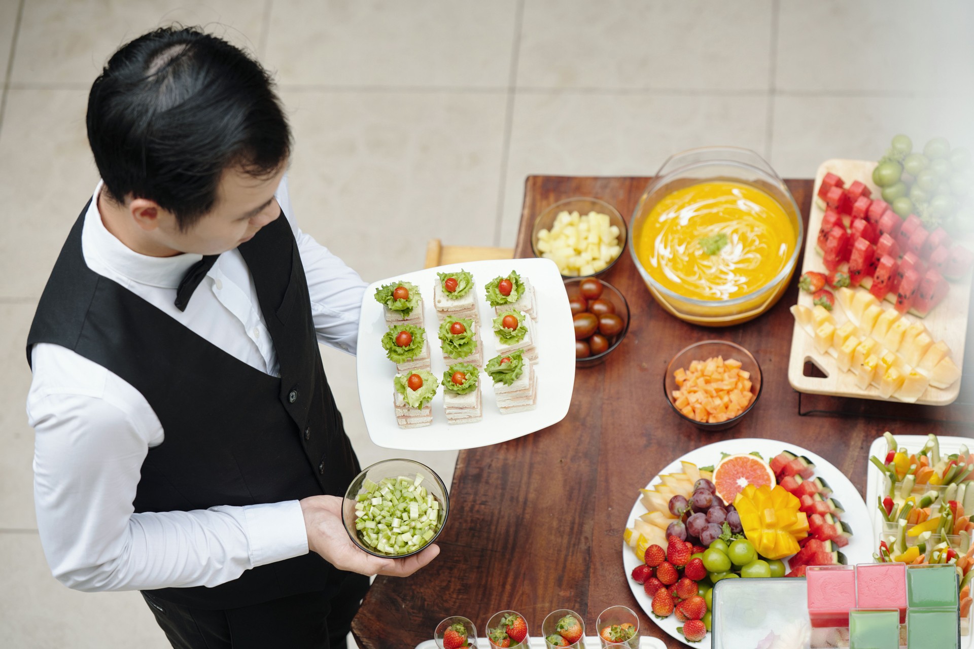 Preparing Delicious Appetizer Plates at Catered Event